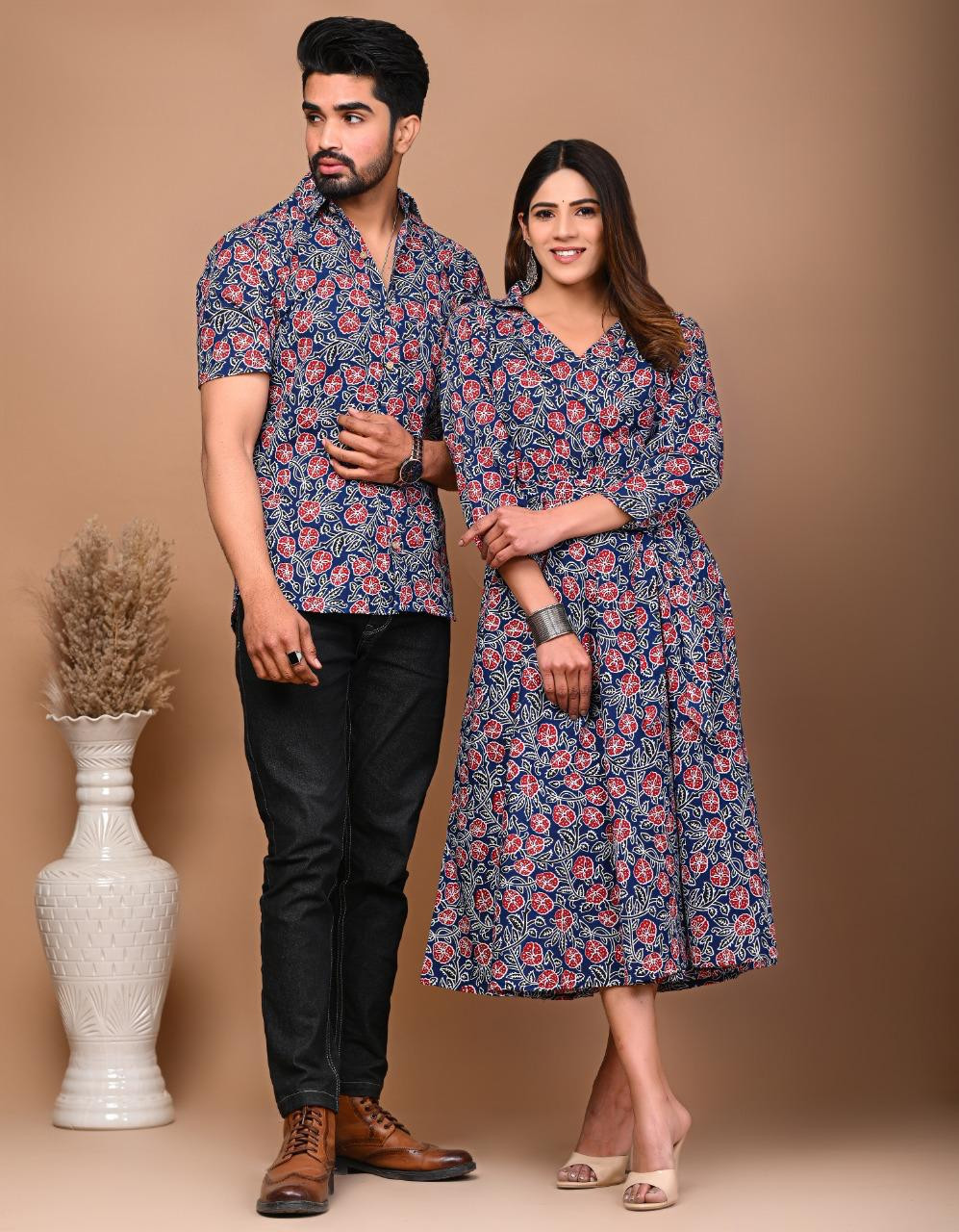 A matching couple's outfit in a blue and red traditional hand block print design, made from a cotton material