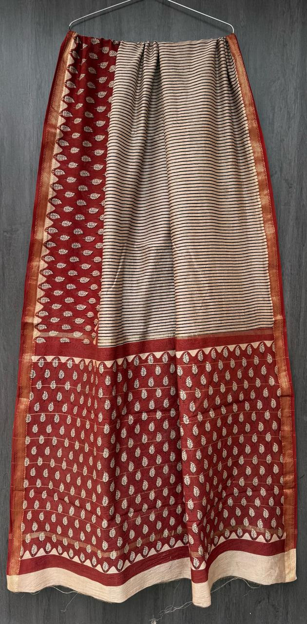 cream and maroon Maheshwari silk-cotton handloom saree featuring a bagh or block-printed leaf pattern and a striped body with a gold zari border design.