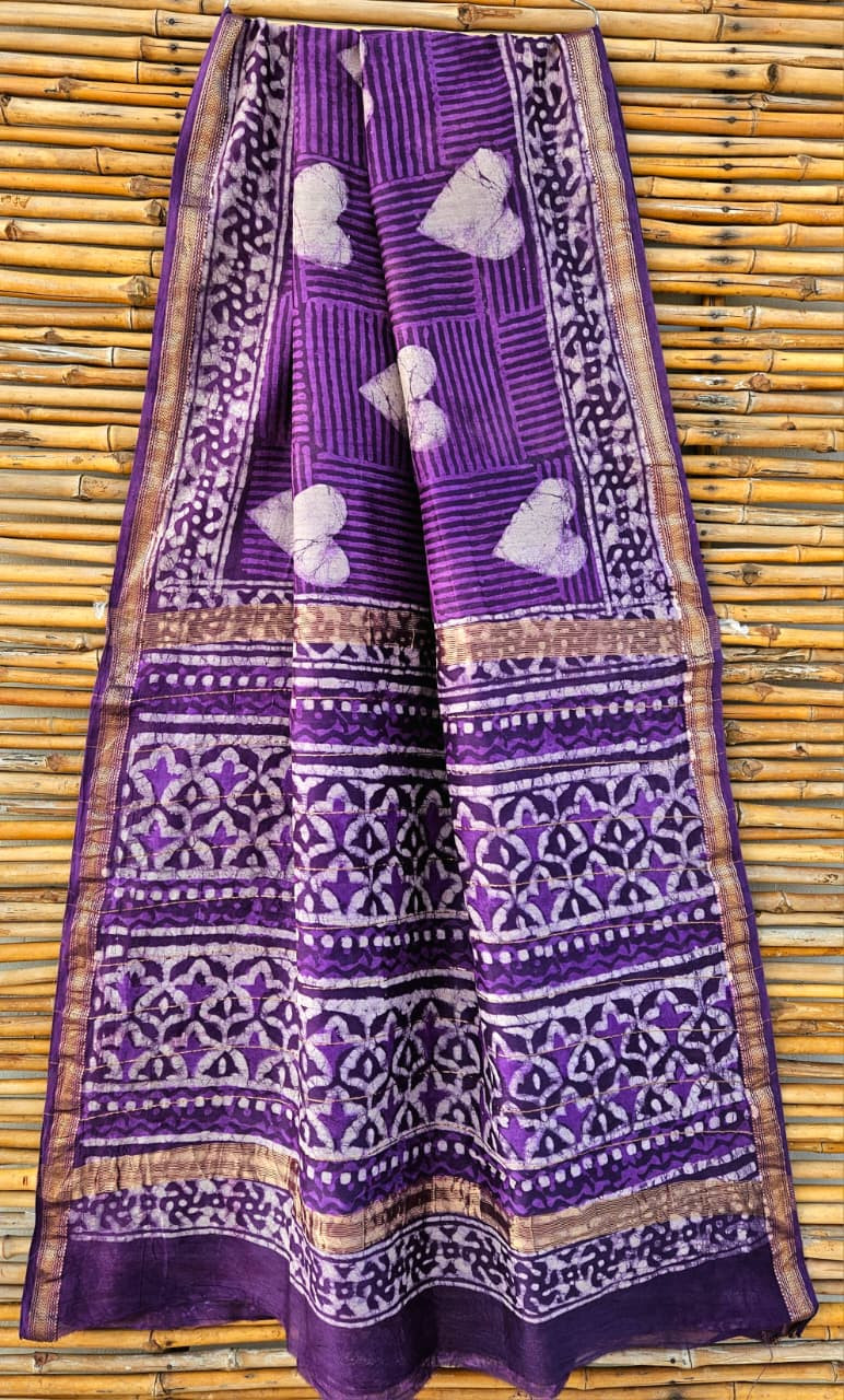 Purple Maheshwari silk cotton blend batik print saree with a gold zari border and traditional motifs