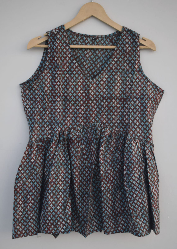 a brown and teal blue hand-block printed, geometric pattern, cotton sleeveless peplum top.