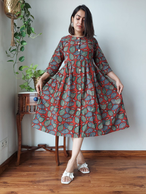 Rust Red Hand Block Printed Cotton One Piece Dress with green and blue leaf patterns and a front button placket.