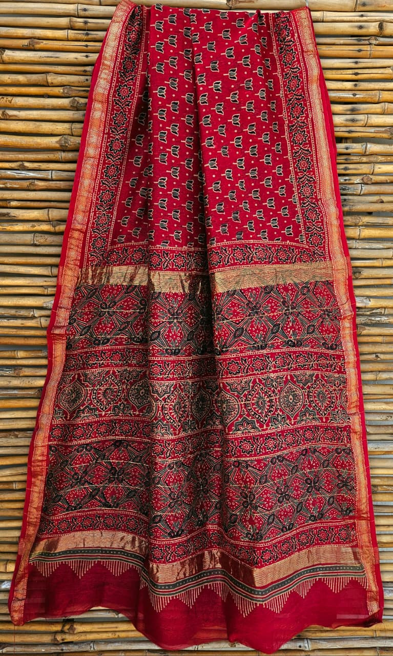 hand-block printed Maheshwari silk/cotton blend saree with traditional motifs in black and white on a red base, finished with a golden zari border.