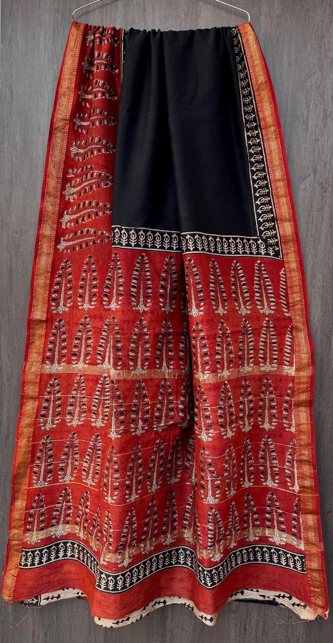 red and black hand-block printed Maheshwari silk/cotton blend saree with traditional motifs and a golden zari border.