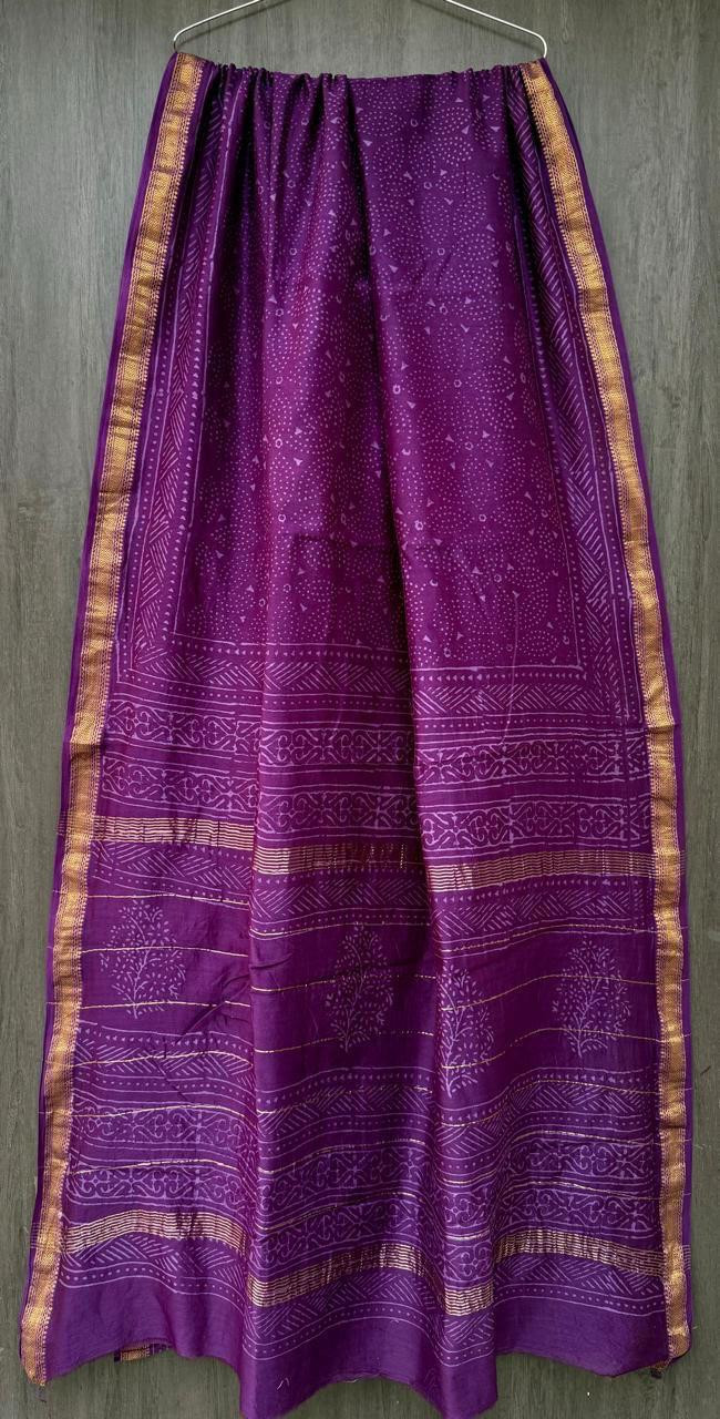 purple hand-block printed Maheshwari or Chanderi silk/cotton blend saree with traditional motifs and a golden zari border.