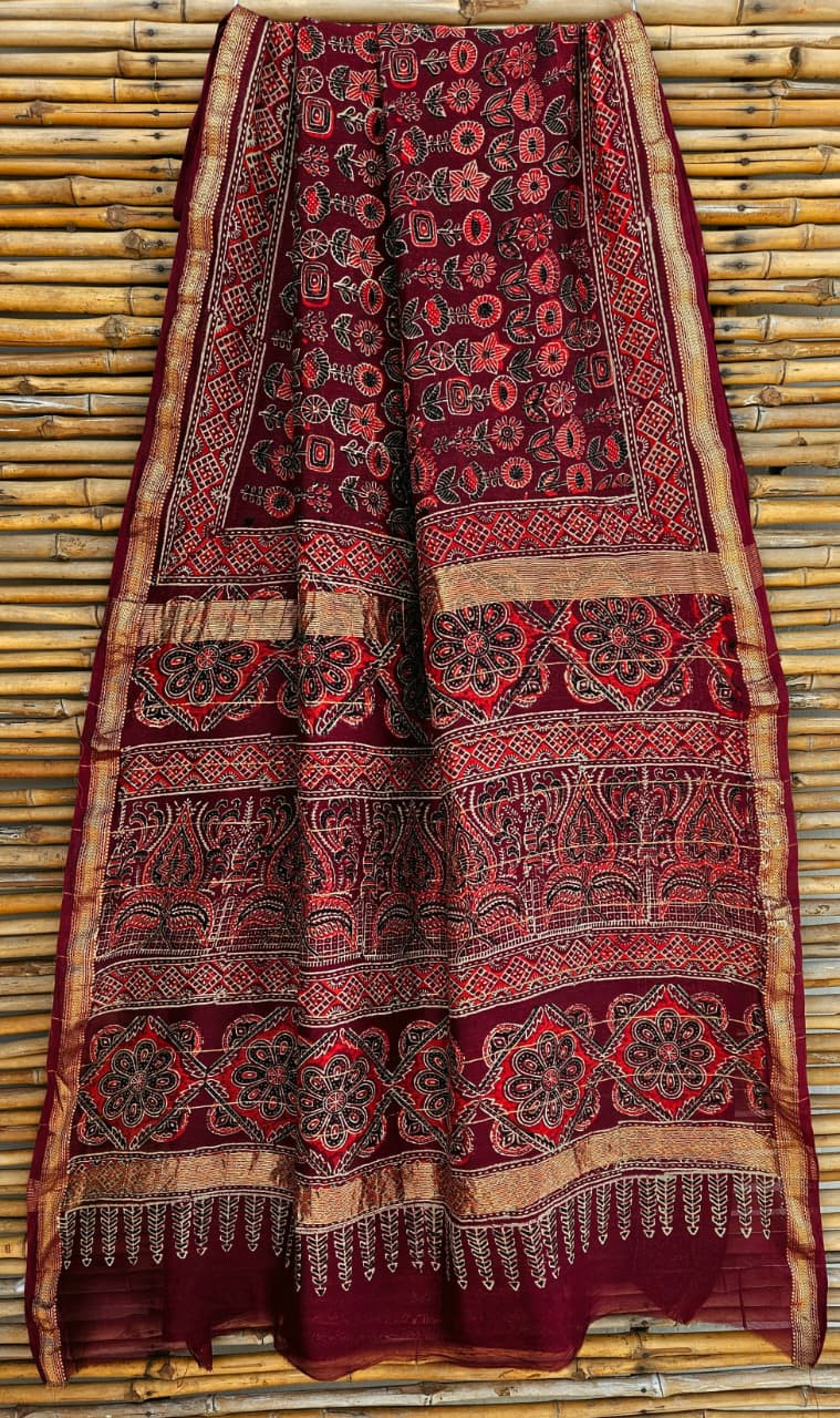 maroon hand-block printed Ajrakh or Maheshwari silk-cotton blend saree with traditional motifs and a golden zari border