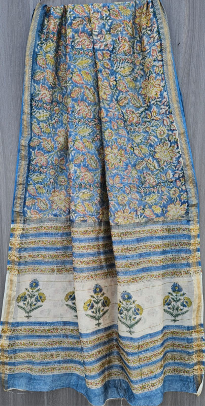 Blue and white Maheshwari silk cotton blend hand block print saree with a pink floral design and gold zari border.