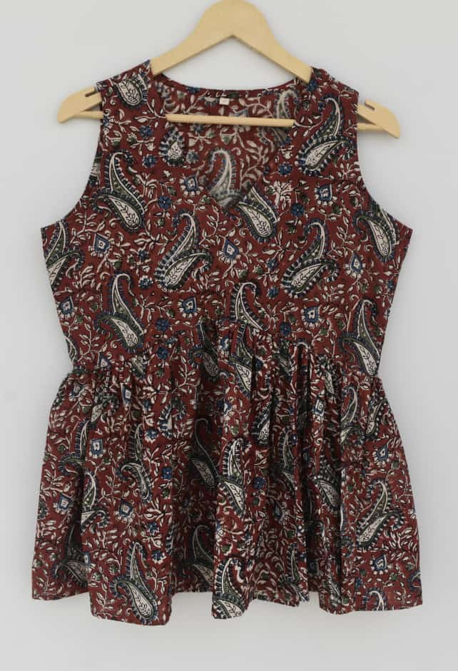 reddish-brown, blue, and off-white hand-block printed, paisley pattern, cotton sleeveless peplum top.