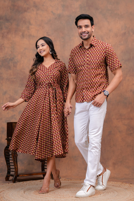 A matching couple's outfit in a maroon and yellow traditional hand block print design, made from a cotton material