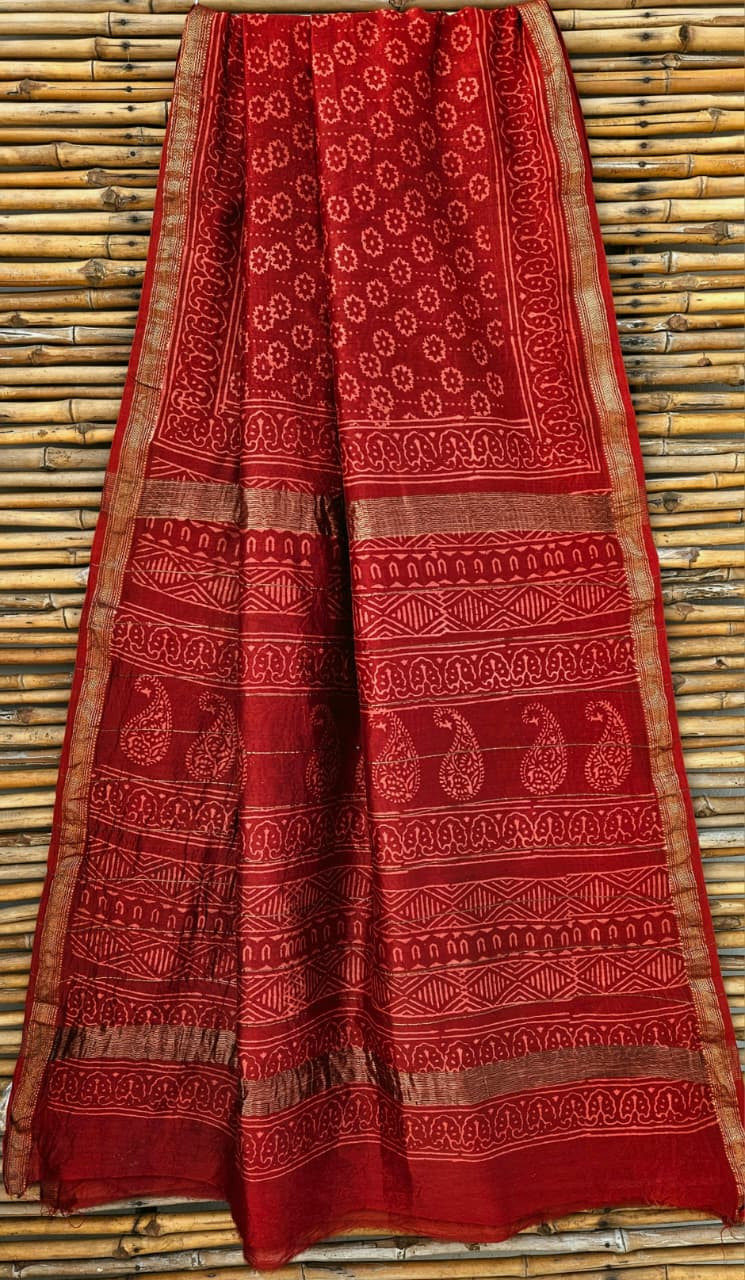 red hand-block printed Maheshwari silk-cotton blend saree with a gold zari border.
